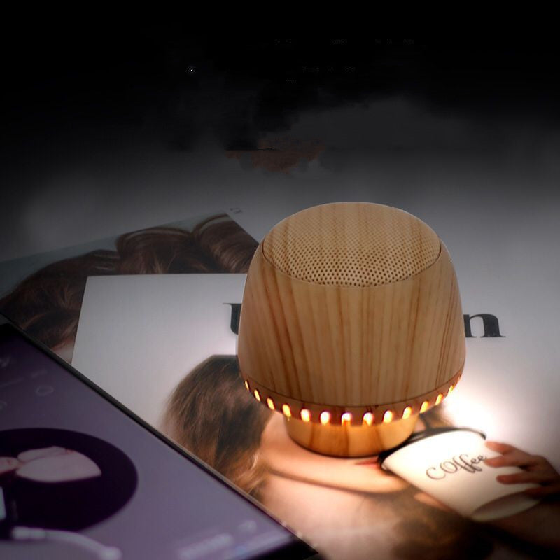 LuxeGlow Essentials portable mushroom-shaped TWS audio pair with LED night light and small charging box, designed for convenient use.