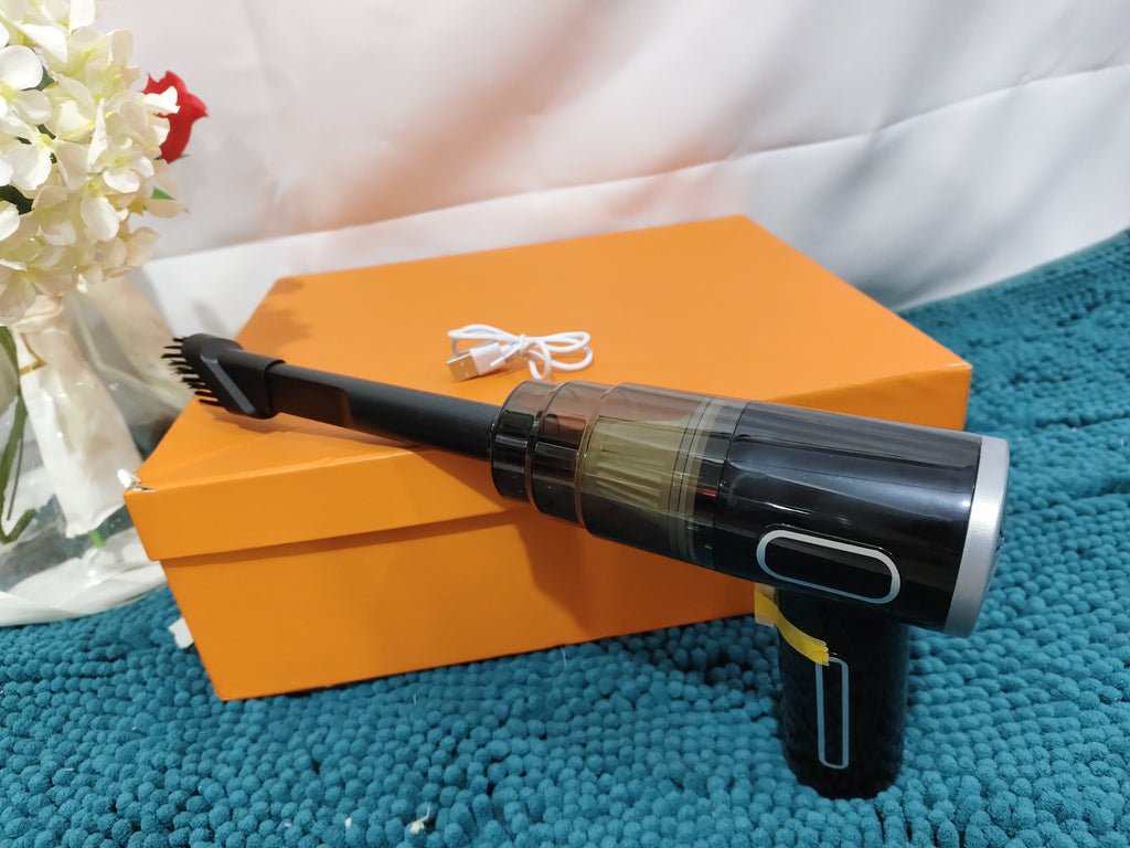 PureGlow portable car vacuum cleaner, compact car accessory with hose attachment for cleaning vehicle interior surfaces.