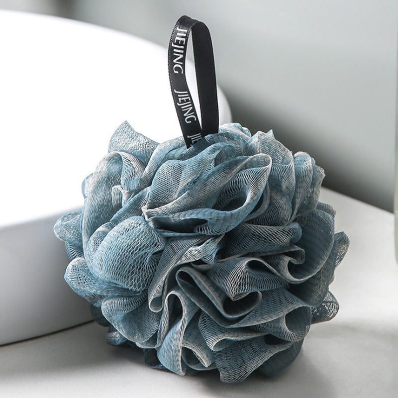 PureGlow soft bubble bath loofah ball for gentle exfoliation and luxurious bathing, shown in a close-up image.