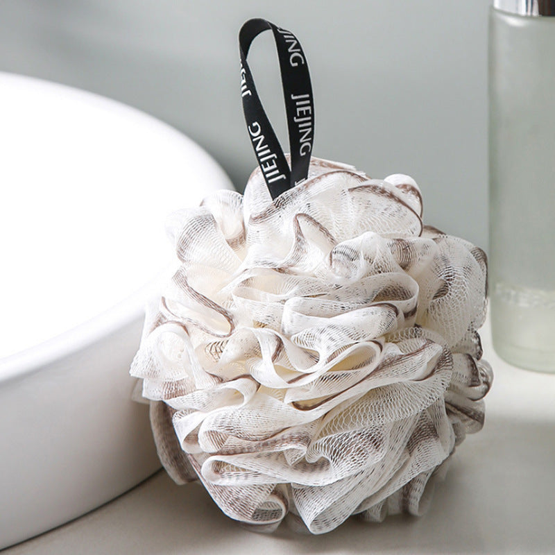 PureGlow soft bubble bath loofah ball for gentle exfoliation and luxurious bathing experience, shown in the image.