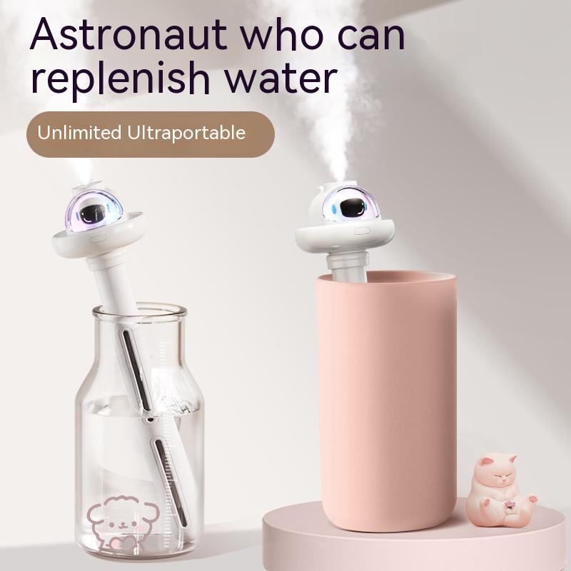PureGlow astronaut-shaped portable mini humidifier on a home appliance table with mist visible.