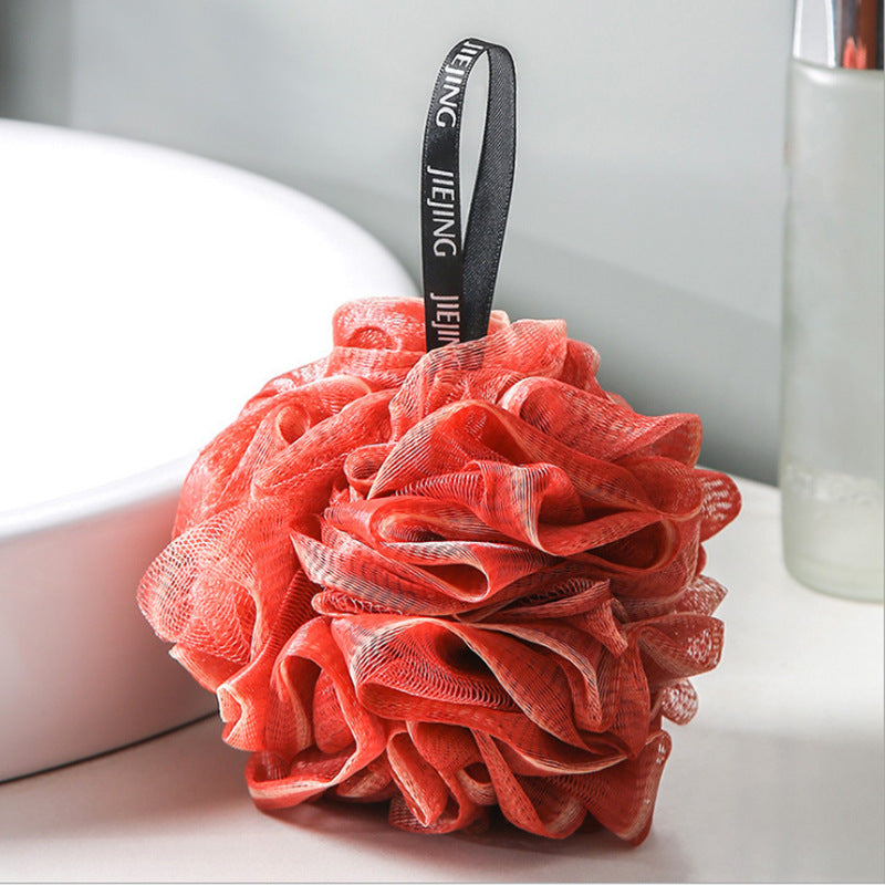 PureGlow soft bubble bath loofah ball for gentle exfoliation and luxurious bathing, shown in close-up with a soft texture.