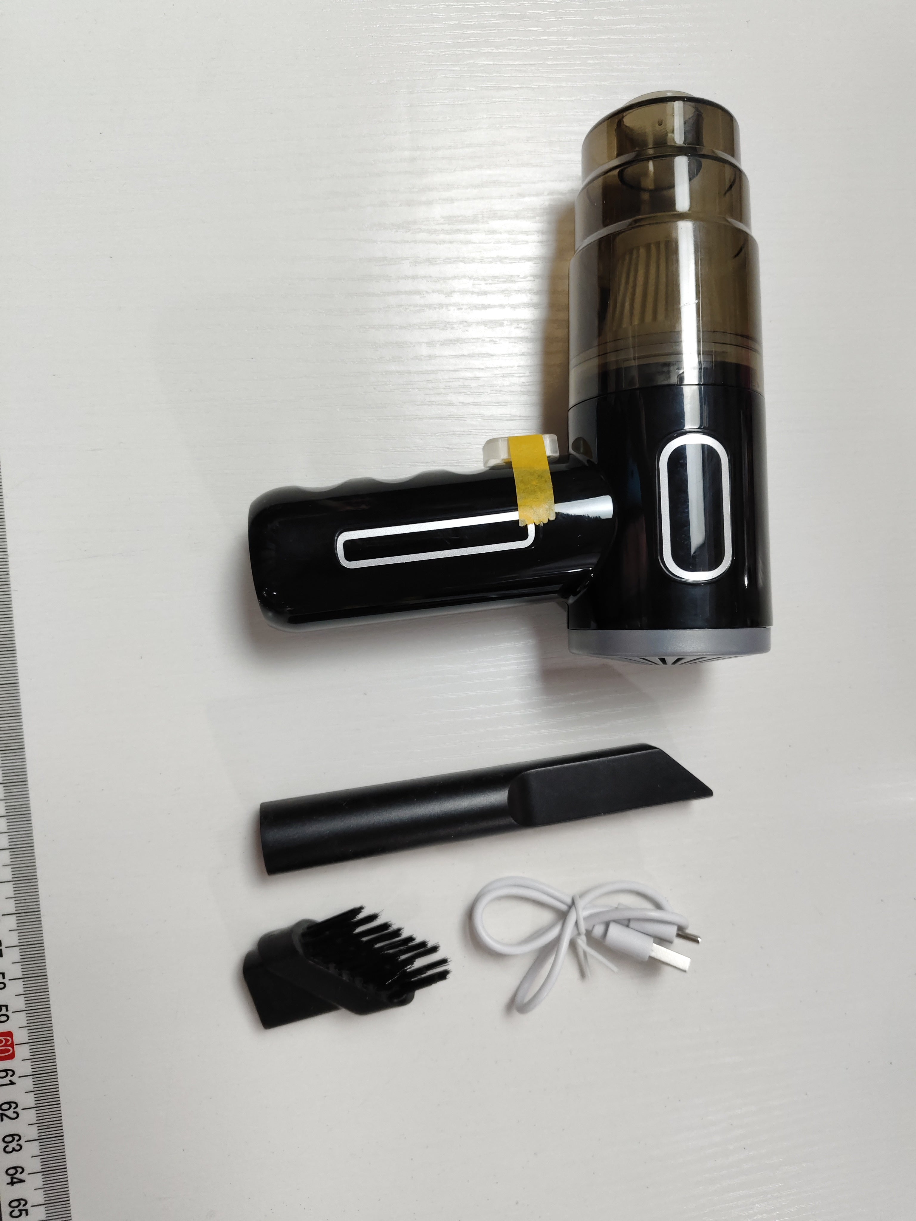 PureGlow portable car vacuum cleaner shown with compact design and hose attachment for car interior cleaning.